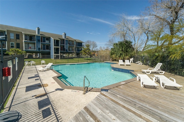 pool with fence and a wooden deck