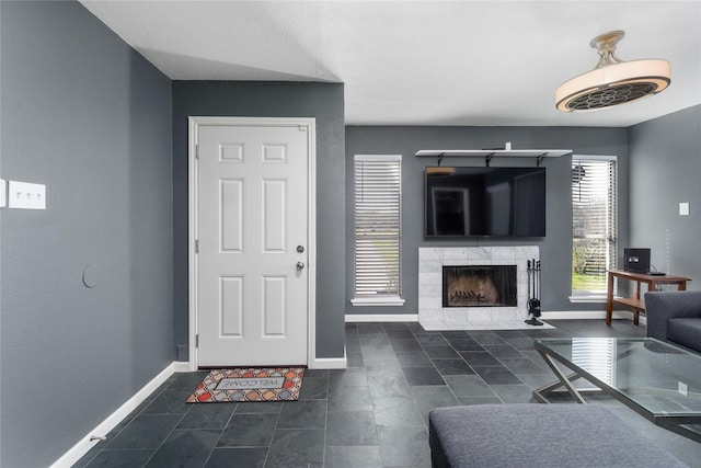 living room featuring a fireplace and baseboards