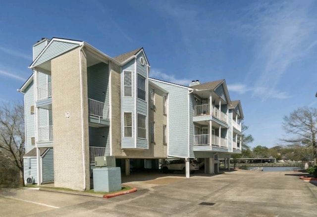 view of building exterior with a carport and concrete driveway