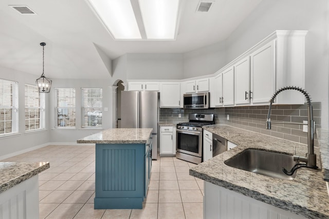 kitchen with visible vents, appliances with stainless steel finishes, white cabinets, and a sink