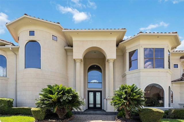 doorway to property with french doors and stucco siding