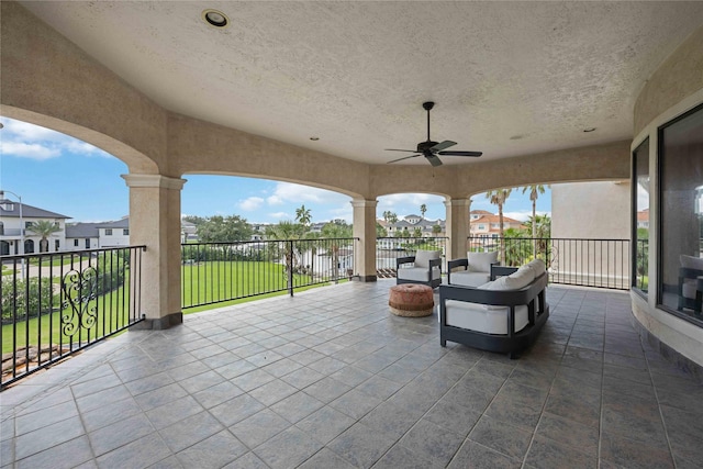 view of patio / terrace with a water view, ceiling fan, and an outdoor living space