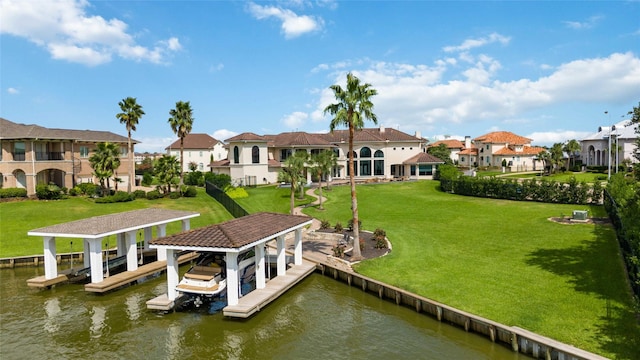 dock area featuring a residential view, a lawn, boat lift, and a water view