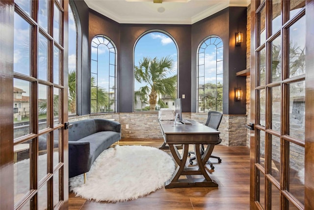 office featuring wood-type flooring, a healthy amount of sunlight, crown molding, and french doors