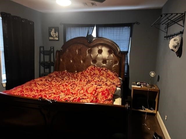 bedroom with visible vents and baseboards