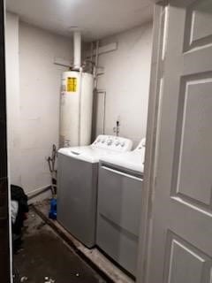 laundry area with laundry area, gas water heater, and washer and dryer