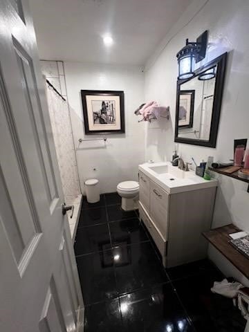 bathroom with a shower with curtain, toilet, vanity, and tile patterned flooring