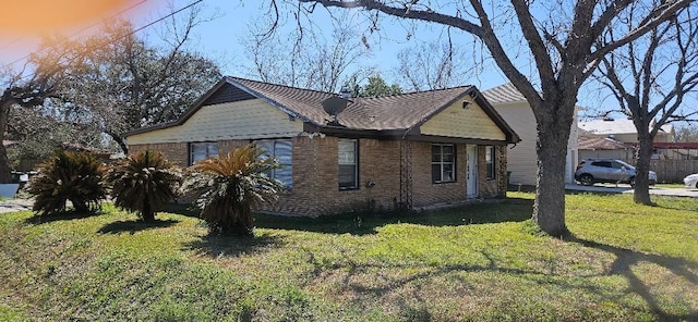 view of home's exterior with a yard and brick siding