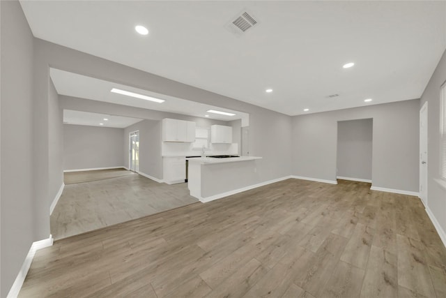 unfurnished living room with baseboards, light wood finished floors, visible vents, and recessed lighting