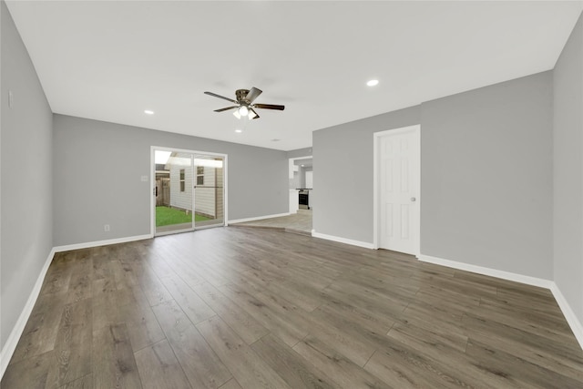 unfurnished living room featuring recessed lighting, wood finished floors, a ceiling fan, and baseboards