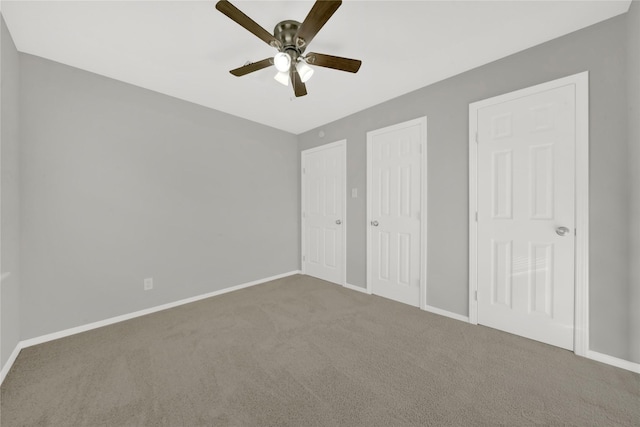 unfurnished bedroom featuring carpet floors, a ceiling fan, and baseboards