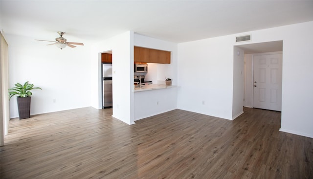 unfurnished living room with a ceiling fan, baseboards, visible vents, and dark wood-type flooring