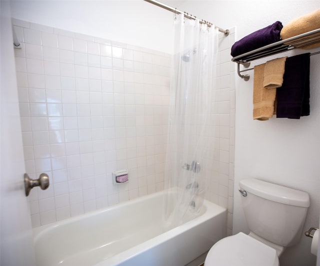 full bathroom featuring toilet and shower / bath combination with curtain