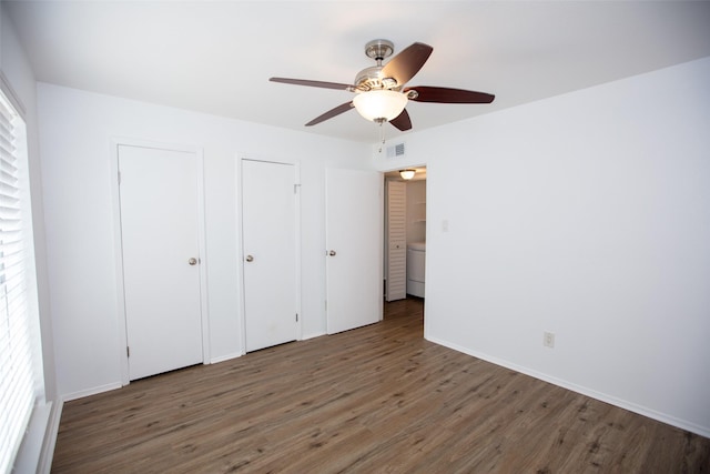 unfurnished bedroom featuring ceiling fan, wood finished floors, visible vents, and baseboards