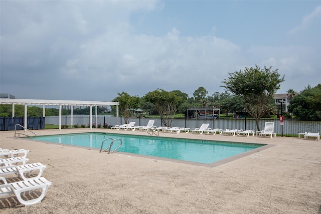 community pool featuring fence, a pergola, and a patio