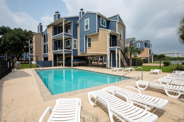 pool featuring a patio and fence