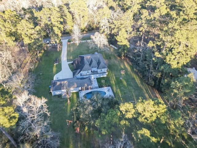 drone / aerial view with a wooded view