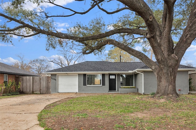 view of front facade featuring brick siding, fence, concrete driveway, roof with shingles, and a garage