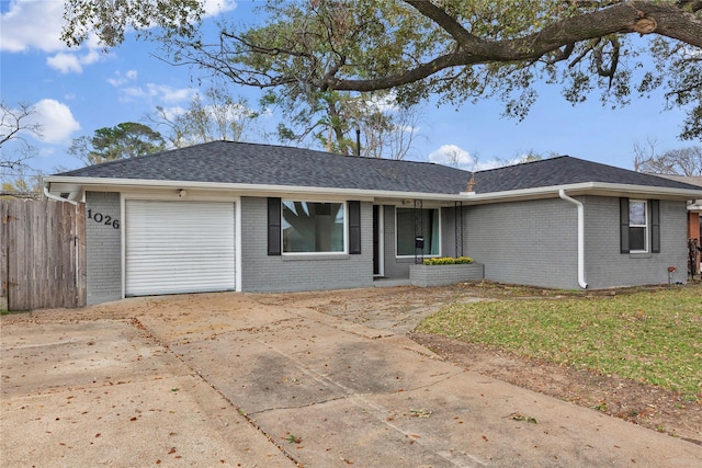 ranch-style house featuring brick siding, a garage, and driveway