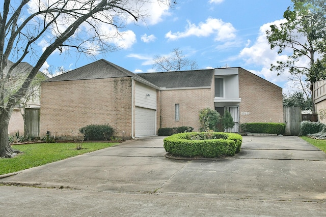 mid-century home featuring a front yard, concrete driveway, brick siding, and fence