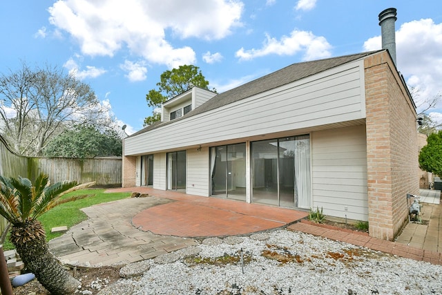 back of property with a patio area and fence