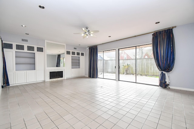 unfurnished living room featuring visible vents, built in features, ceiling fan, a fireplace, and light tile patterned flooring