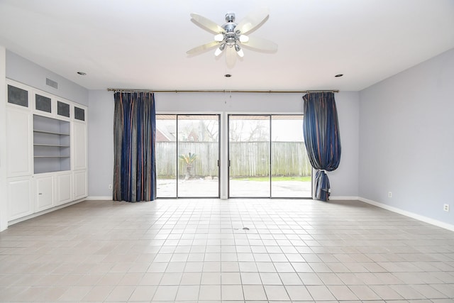 unfurnished room featuring light tile patterned floors, baseboards, visible vents, and ceiling fan