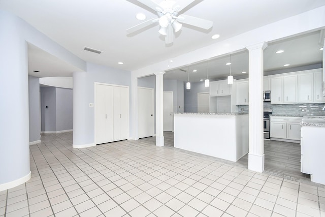 unfurnished living room with decorative columns, recessed lighting, visible vents, ceiling fan, and baseboards