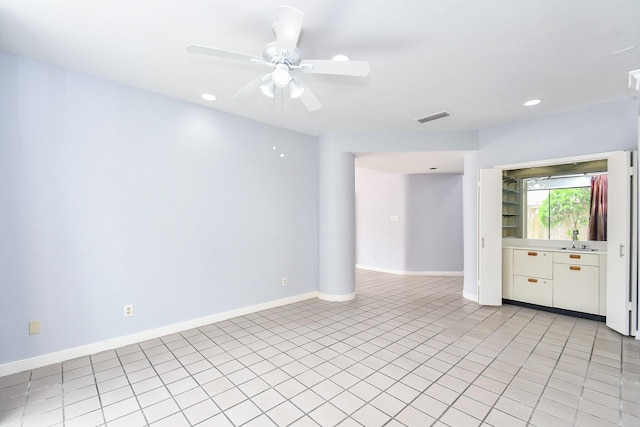 spare room featuring recessed lighting, visible vents, a sink, ceiling fan, and baseboards