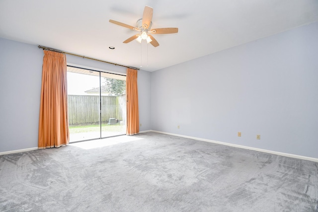 unfurnished room with carpet floors, a ceiling fan, and baseboards