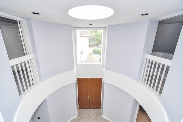 hallway with recessed lighting and light tile patterned flooring