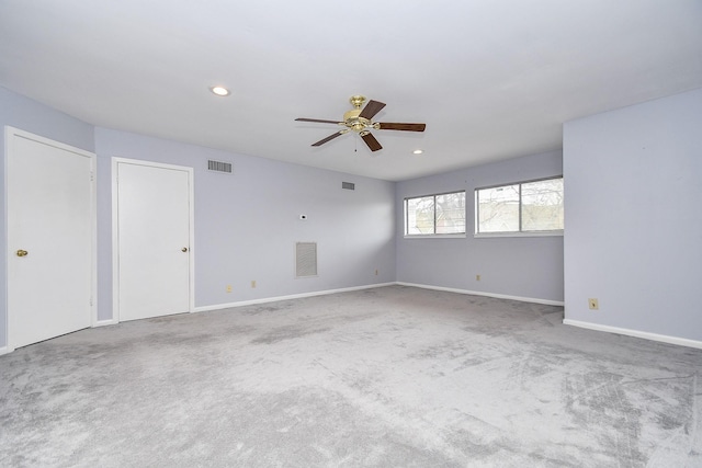 carpeted spare room featuring recessed lighting, visible vents, and baseboards