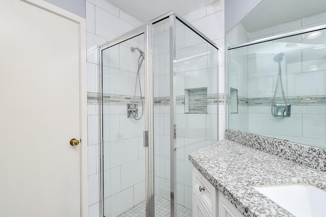 full bathroom featuring vanity and a shower stall