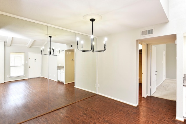 unfurnished dining area with beam ceiling, dark wood finished floors, a notable chandelier, visible vents, and baseboards