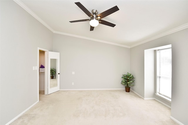 spare room featuring baseboards, ceiling fan, ornamental molding, and light colored carpet