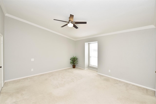 empty room featuring baseboards, ceiling fan, ornamental molding, and light colored carpet