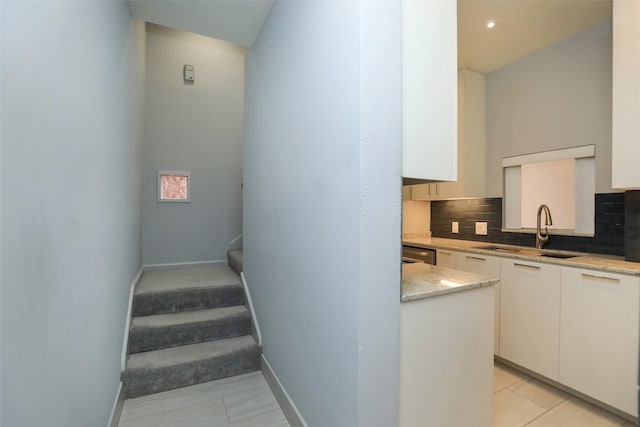 staircase featuring tile patterned flooring and baseboards