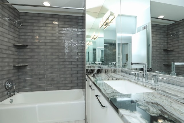 bathroom with shower / bath combination, visible vents, and vanity