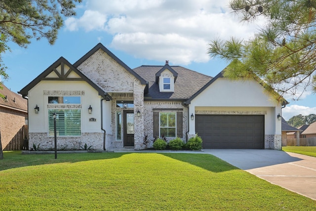 view of front facade featuring driveway, brick siding, an attached garage, a front yard, and stucco siding