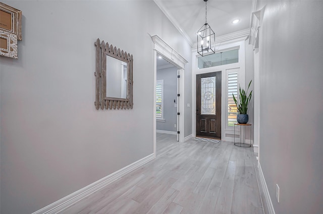 entrance foyer featuring ornamental molding, recessed lighting, light wood-style flooring, and baseboards