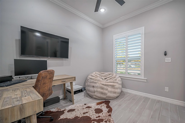 office space with a ceiling fan, light wood-type flooring, crown molding, and baseboards