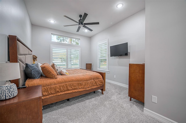 bedroom featuring a ceiling fan, recessed lighting, light colored carpet, and baseboards