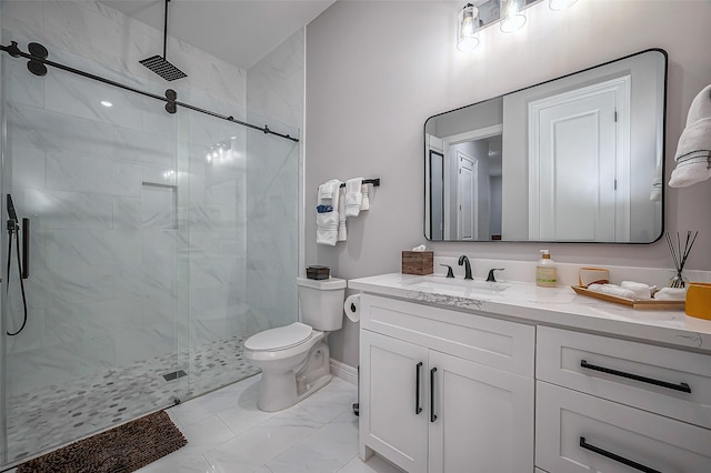 bathroom with toilet, vanity, baseboards, marble finish floor, and a stall shower