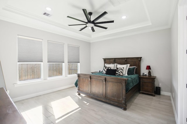 bedroom with visible vents, crown molding, light wood-style flooring, and baseboards