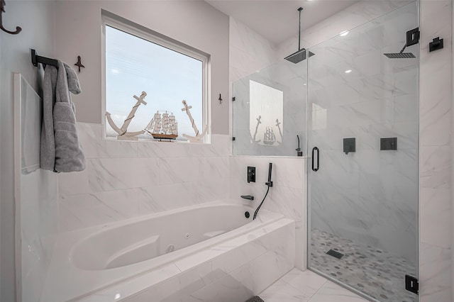 bathroom featuring a jetted tub, marble finish floor, and a shower stall