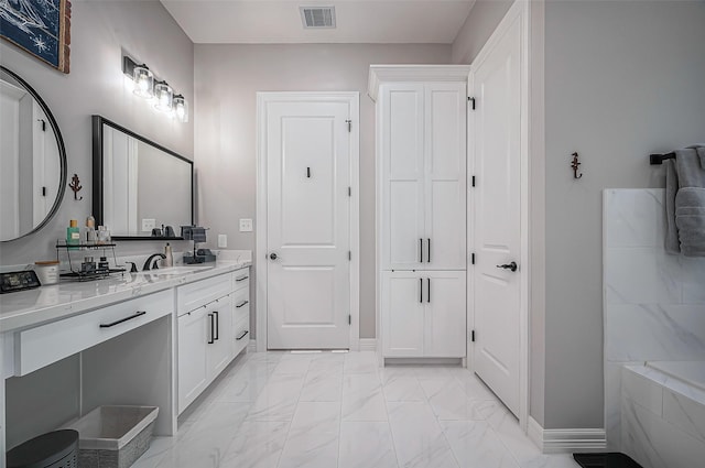 full bath featuring a bath, marble finish floor, vanity, and visible vents