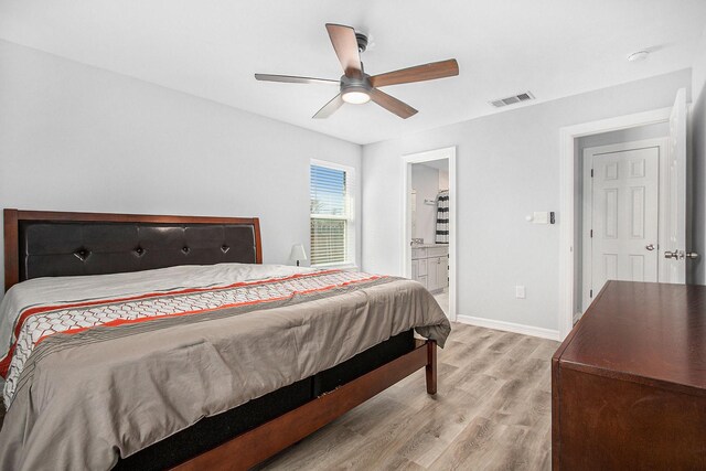 bedroom featuring light wood finished floors, baseboards, visible vents, a ceiling fan, and ensuite bathroom