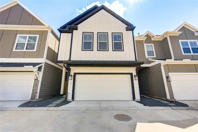 townhome / multi-family property with an attached garage, board and batten siding, and concrete driveway