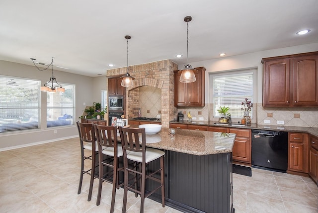 kitchen featuring dishwasher, tasteful backsplash, stainless steel microwave, and a sink