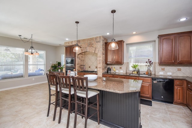 kitchen featuring decorative backsplash, a sink, appliances with stainless steel finishes, and a healthy amount of sunlight